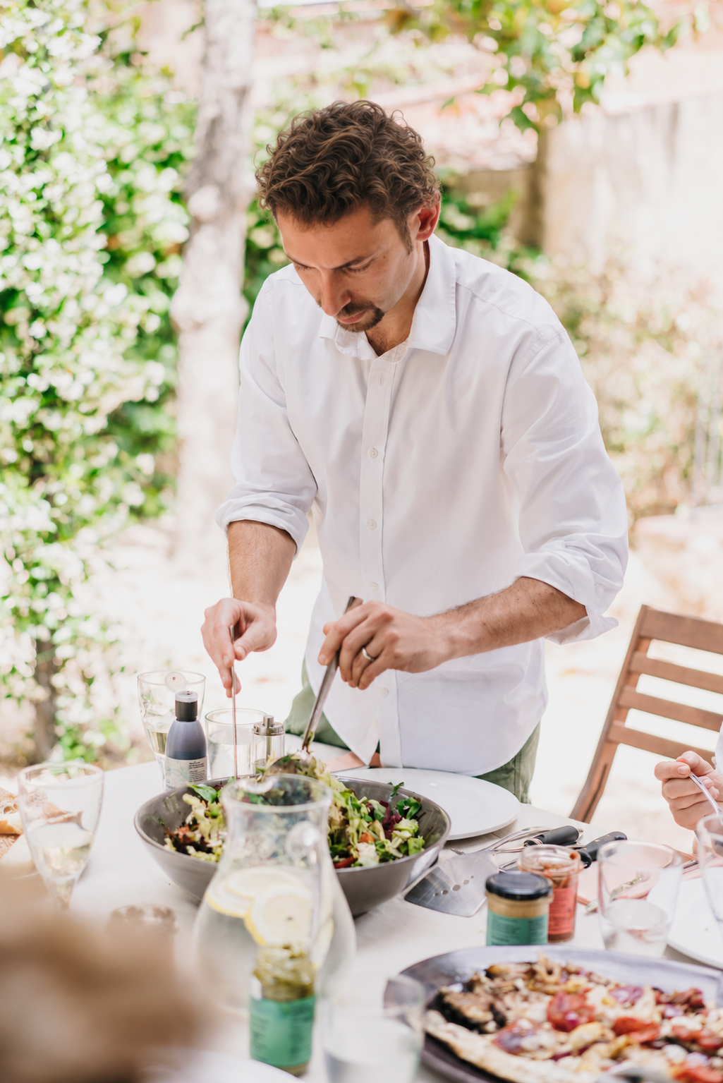 Ricky Mandle preparing food at an outdoor table